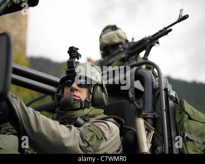 U.S. Special Forces on patrol in a special operation vehicle. Stock Photo