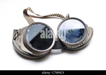 Used welding goggles with fingerprints over white background Stock Photo