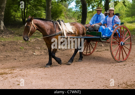 Unidentified participants take a carriage ride in the annual festival 'Patria Gaucha'  in Tacuarembo, Uruguay. Stock Photo