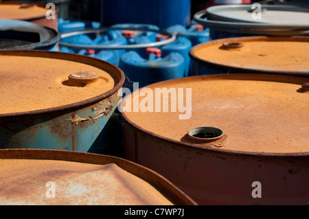 Old colored barrels for oil products. Empty rusted drums Stock Photo