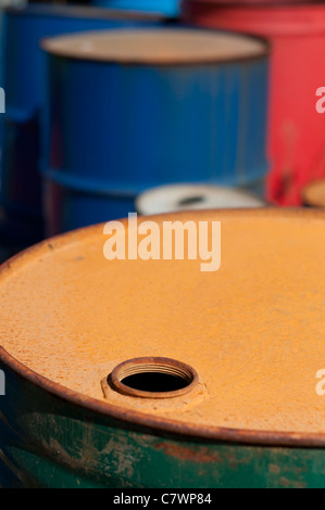 Old colored barrels for oil products. Empty rusted drums Stock Photo