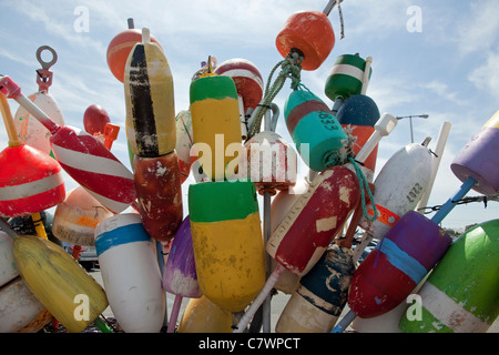 Colorful lobster trap buoys on display at a dock on Cape Cod. Stock Photo