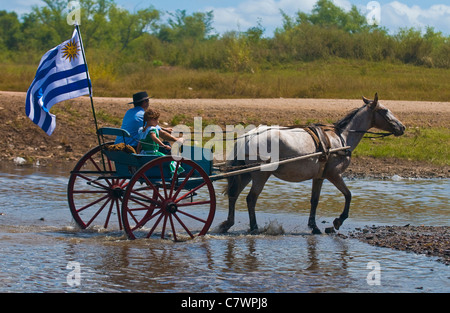 Unidentified participants take a carriage ride in the annual festival 'Patria Gaucha'  in Tacuarembo, Uruguay. Stock Photo