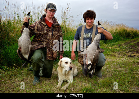 Young adolescents yellow labrador retirever Waterfowl Heritage Days Hunt Canada Geese Stock Photo