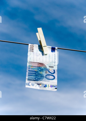Concept representing money laundering Euro 20 note pegged on a washing line Stock Photo