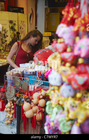 Woman looking at souvenirs in Chinatown, Singapore Stock Photo