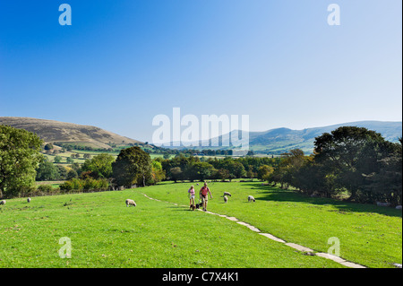 Walkers on The Pennine Way near its start in Edale looking towards the village, Peak District National Park, Derbyshire, England Stock Photo