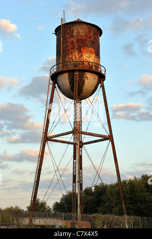 An old rusting industrial or city  water tower in a suburb of Tampa Florida, USA. Stock Photo