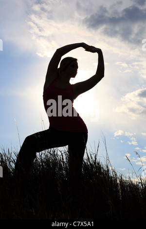 The silhouette of a gymnast stretching in a field Stock Photo - Alamy