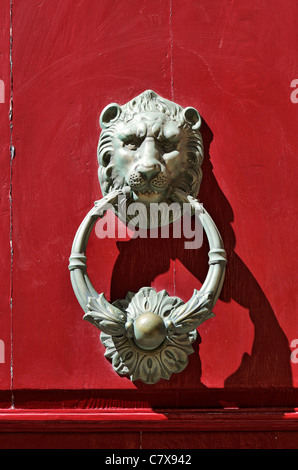 Bronze lion door knocker on red door in Mdina, Malta. Stock Photo