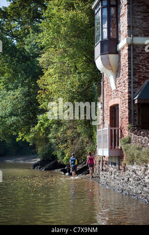 Ramblers with Dog at Stoke Gabriel,Devon, Wading through the river Dart to secluded beach,peace, serene, tranquil, cove,water Stock Photo