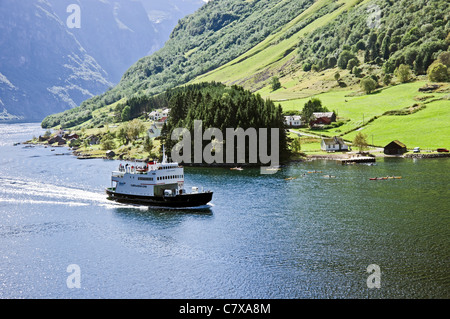 The narrows at Bakke on the Nœröyfjorden in Western Norway with Fjord1 car and passenger ferry Fjœrlandsfjord passing through Stock Photo