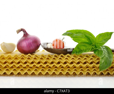 raw lasagna sheets with spices on white background Stock Photo