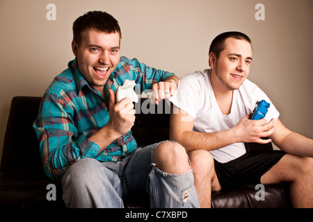 Two attractive guys having fun while playing video games Stock Photo