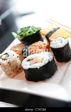 Sushi food on a white plate in a restaurant Stock Photo