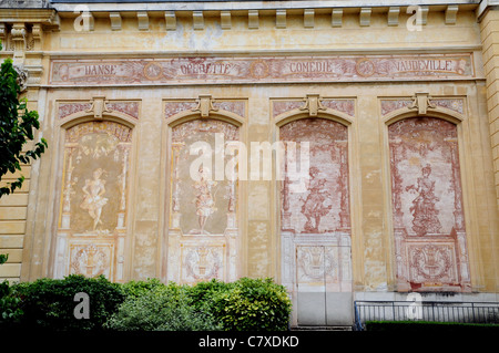 The classical frescos on the exterior wall of the Theatre Andre Messager, Neris les Bains, Allier, France Stock Photo
