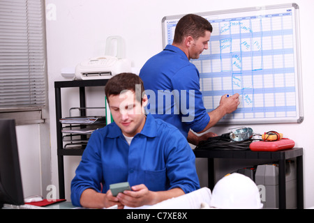 Two electricians working in back office Stock Photo