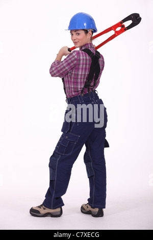young woman holding big pliers Stock Photo