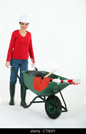 laborer carrying a wheelbarrow at a construction site Stock Photo - Alamy
