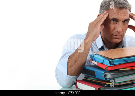 Man sat in front of paperwork Stock Photo