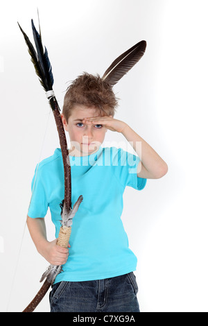 Child playing bow and arrows Stock Photo