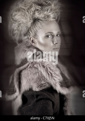 Girl wearing fur coat looking over her shoulder Stock Photo