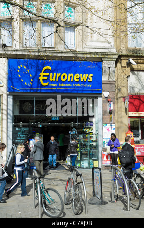 Chain store newsagent in a city centre, with people passing by. Stock Photo