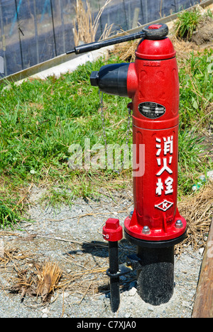 Fire safety in Japan: bright red roadside fire hydrant. Stock Photo