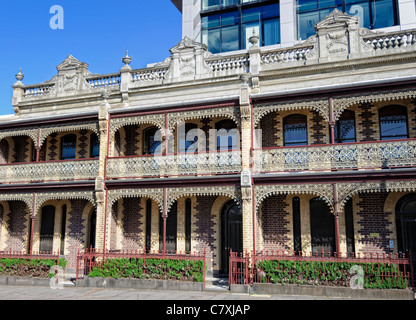 Colonial Victorian terraced housing, with elaborate brickwork and ornate iron balcony railings Stock Photo