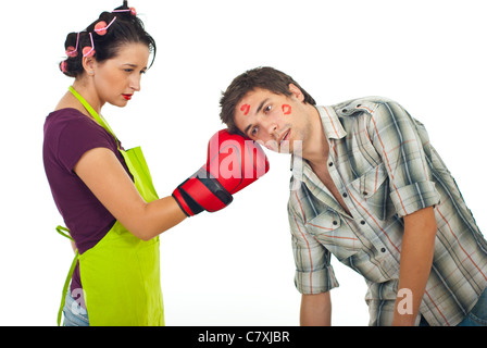 Angry wife boxing unfaithful husband isolated on white background Stock Photo