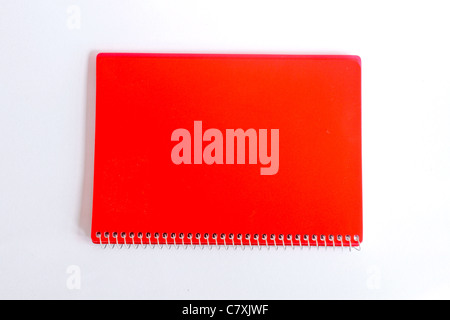 isolated red notebook on white color background Stock Photo