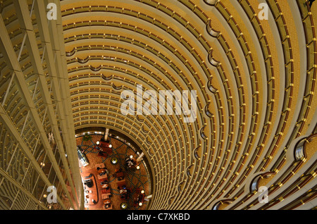 The lobby bar of the Grand Hyatt hotel sits at the bottom of this impressive atrium, located in the Jin Mao Tower. Stock Photo