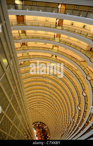 The lobby bar of the Grand Hyatt hotel is at the bottom of this impressive atrium, located inside the Jin Mao Tower. Stock Photo