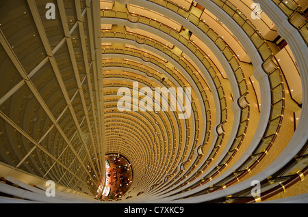 The lobby bar of the Grand Hyatt hotel is at the bottom of this impressive atrium, located inside the Jin Mao Tower. Stock Photo