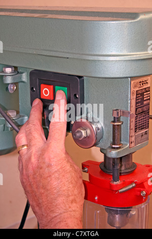 An engineer operates an electric pillar drill, using the chuck tool to secure and drill materials. This process is essential in manufacturing, enabling precise hole drilling in various materials, ensuring accuracy and efficiency in the production process. Stock Photo