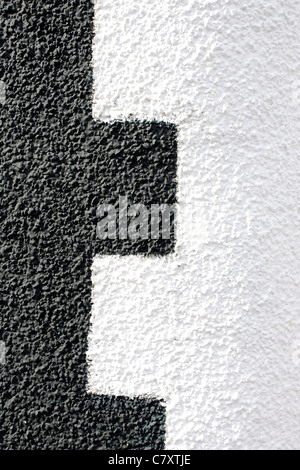 An abstract black and white pattern on a pebble dashed wall. Stock Photo