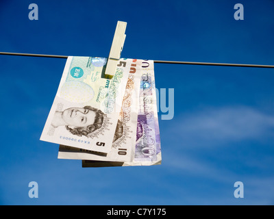 Concept representing money laundering £20 £10 and £5 pegged on a washing line Stock Photo