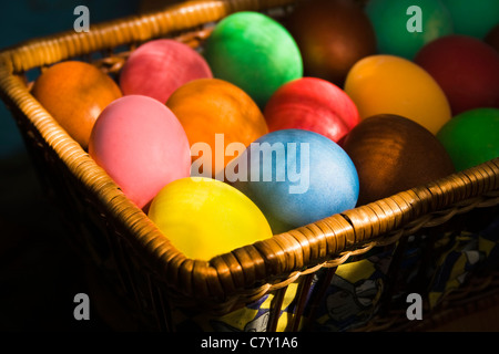 Many-colored Easter eggs lie at the basket Stock Photo
