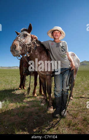Mongolian shepherd boys take break on steppe, Mongolia Stock Photo