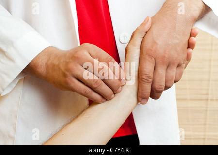 Doctor checking a patients pulse Stock Photo