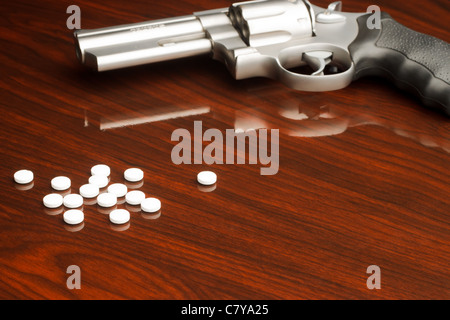 .357 revolver laying on wooden surface with drugs Stock Photo