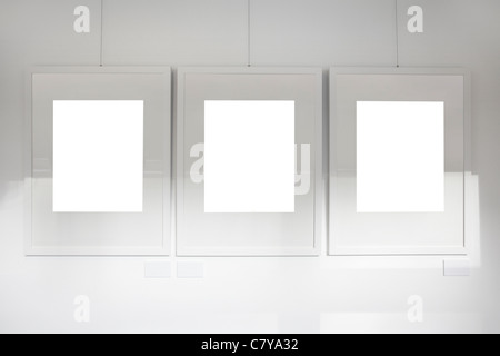Blank frames on art gallery white wall Stock Photo