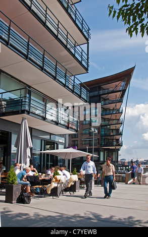 Residential apartment buildings with sidewalk restaurants in Aker Brygge harbor front in Oslo Stock Photo