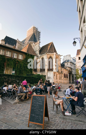 People enjoying a drink at a cafe terrace in Le Marais district - Paris, France Stock Photo