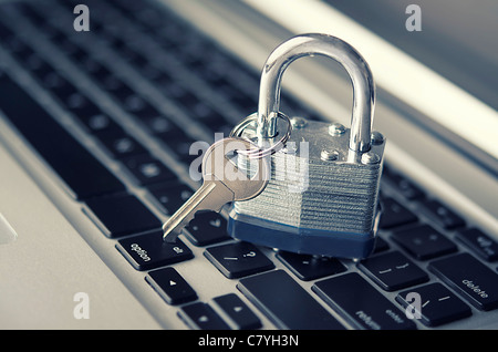 Lock and key on computer keyboard Stock Photo