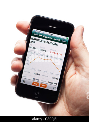 Using a live stock market trading app on a smartphone smart phone mobile phone Stock Photo