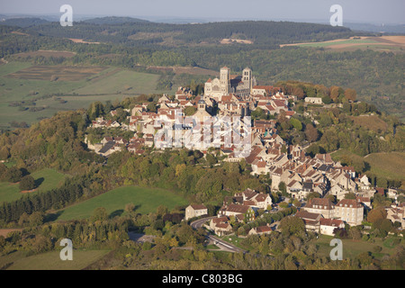 AERIAL VIEW. Small hill town in the countryside, St Mary Magdalene basilica at the top. Vezelay, Yonne, Bourgogne-Franche-Comté, France. Stock Photo