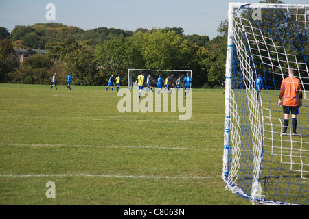 view behind the goal at a Amateur football league game Stock Photo