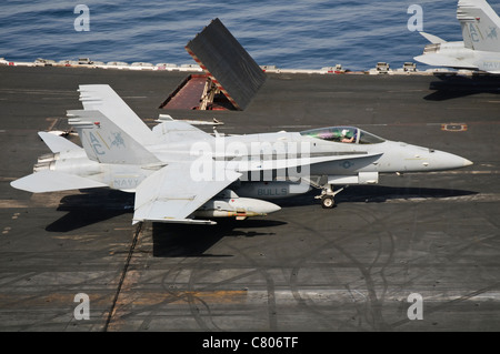 An F/A-18C Hornet sits ready on the flight deck of USS Harry S. Truman. Stock Photo