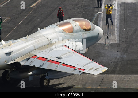 An EA-6B Prowler is guided onto a catapult aboard USS Harry S. Truman. Stock Photo